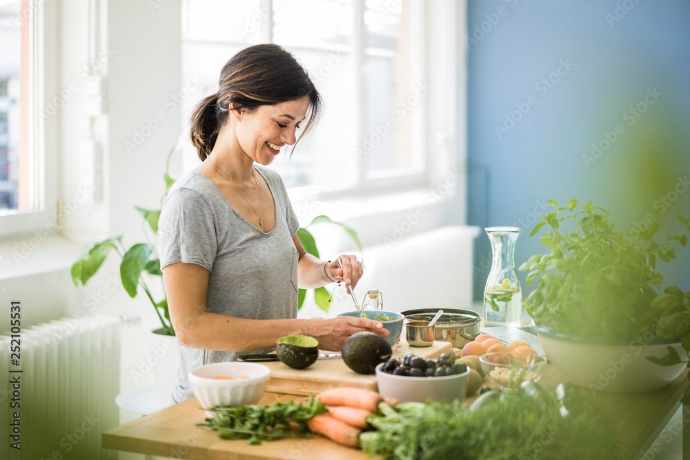 Woman preparing healthy food in her kitchen